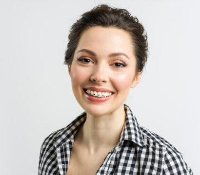 A girl wearing dental braces and smile