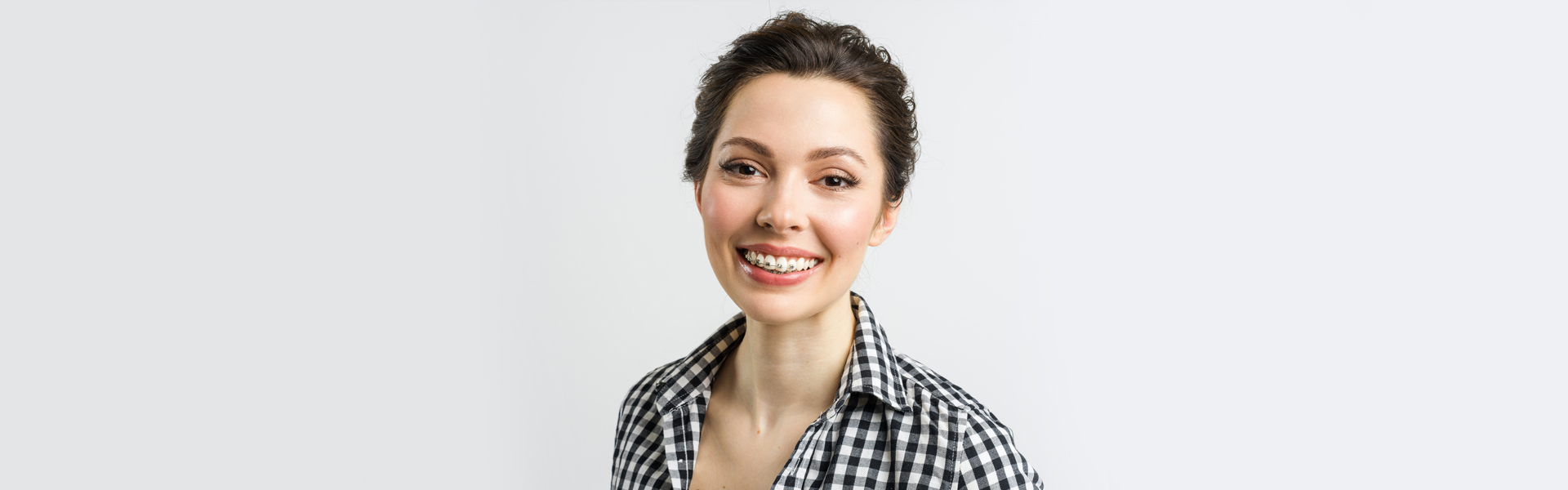 A girl wearing dental braces and smile