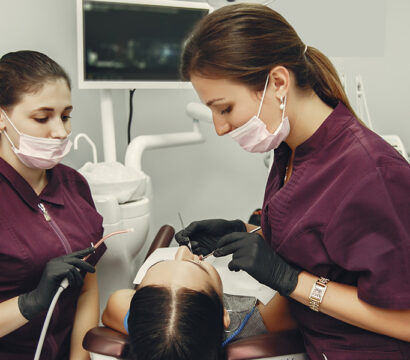 dentists performing procedure in clinic