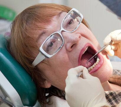 dentist checking lady mouth and teeth