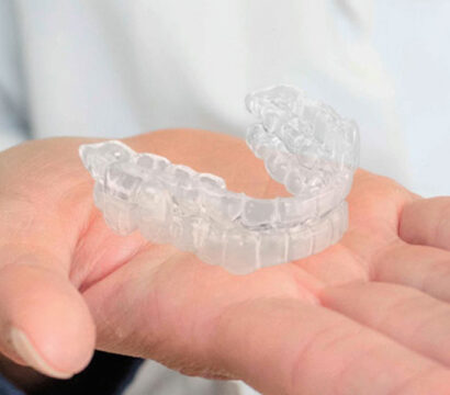 dentist showing Invisalign in his hand